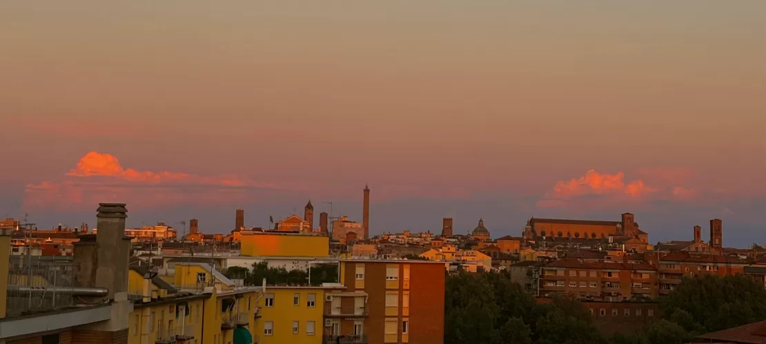 Picture of the sunset of a rooftop over Bologna, Italy