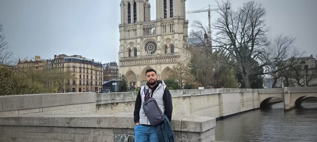 A photo of me standing in front of the Notre Dame Cathedral during my stopover in Paris.