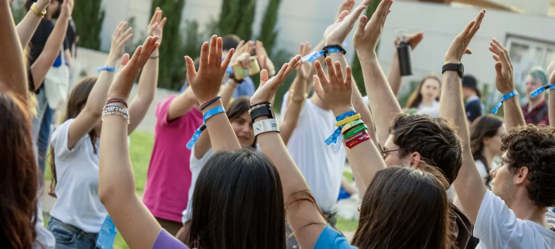 A group of people celebrating EGM Split 2026, their hands in the air