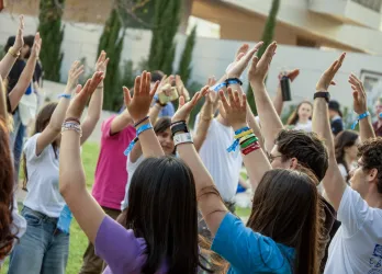 A group of people celebrating EGM Split 2026, their hands in the air