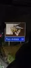 An illuminated road sign for Parc Astérix seen from a bus at night.