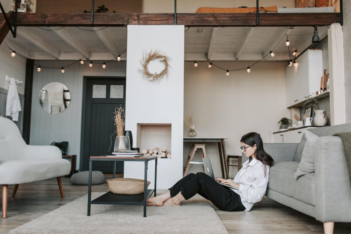 woman sit on the floor working with laptop