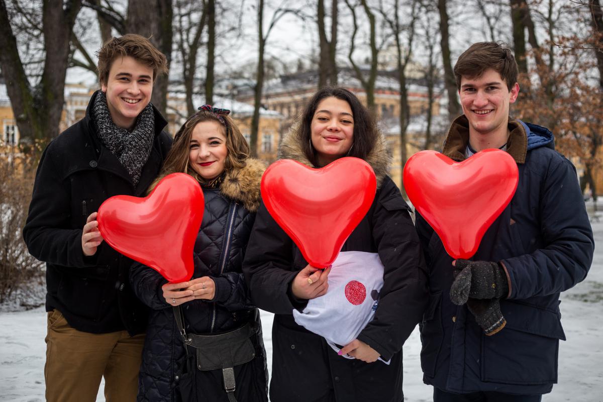 people holding heart shaped ballons