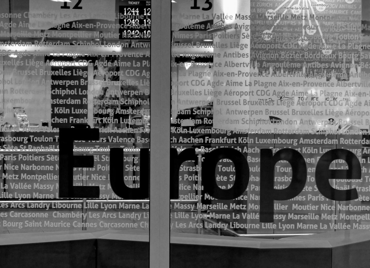 airport glass windows with city names and Europe written in big