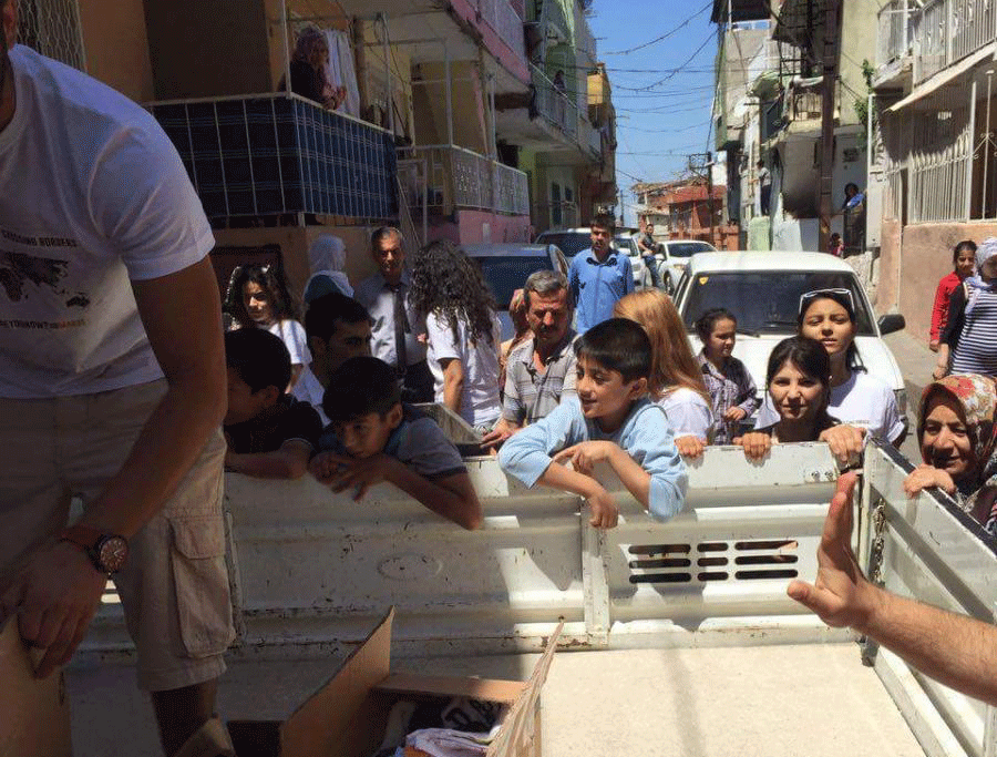 people gathered around someone taking out boxes