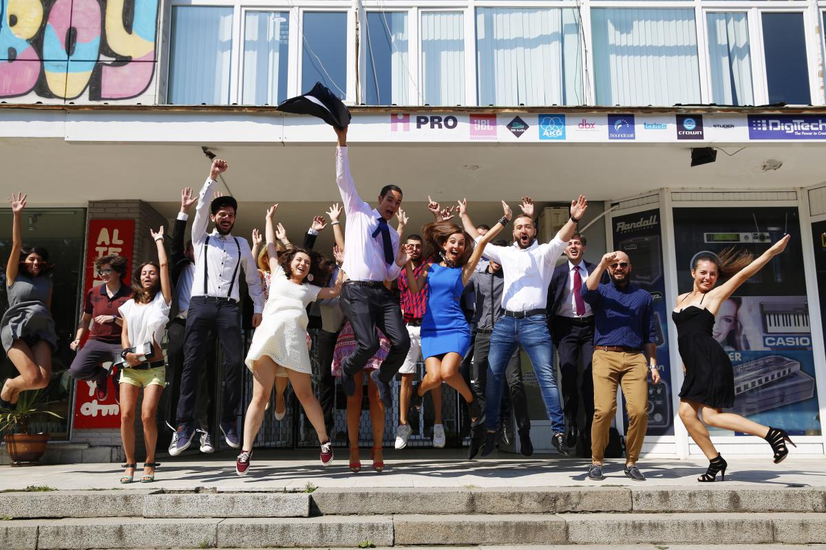 people jumping in front of building