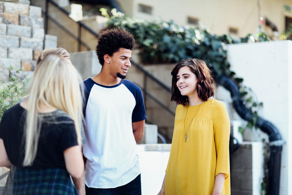 3 people talking in street