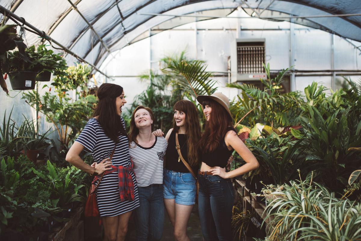 4 women in a greenhouse