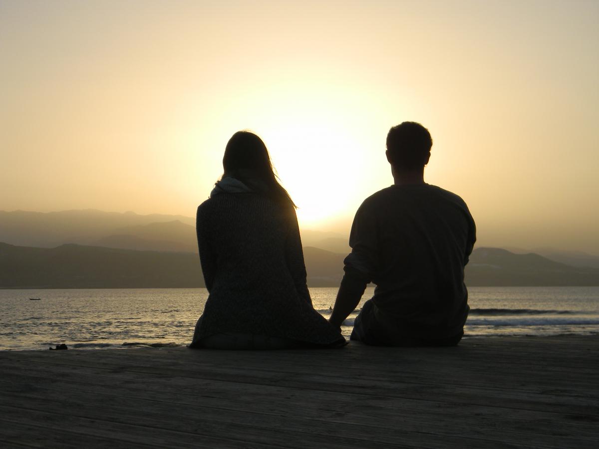 couple looking at the sea, view from back