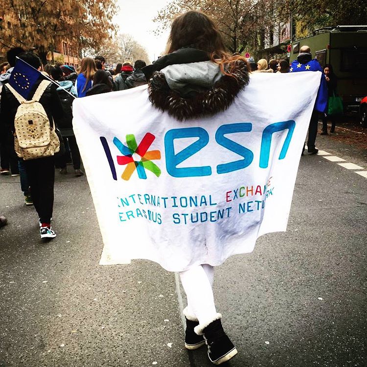 someone walking with an esn flag on the back