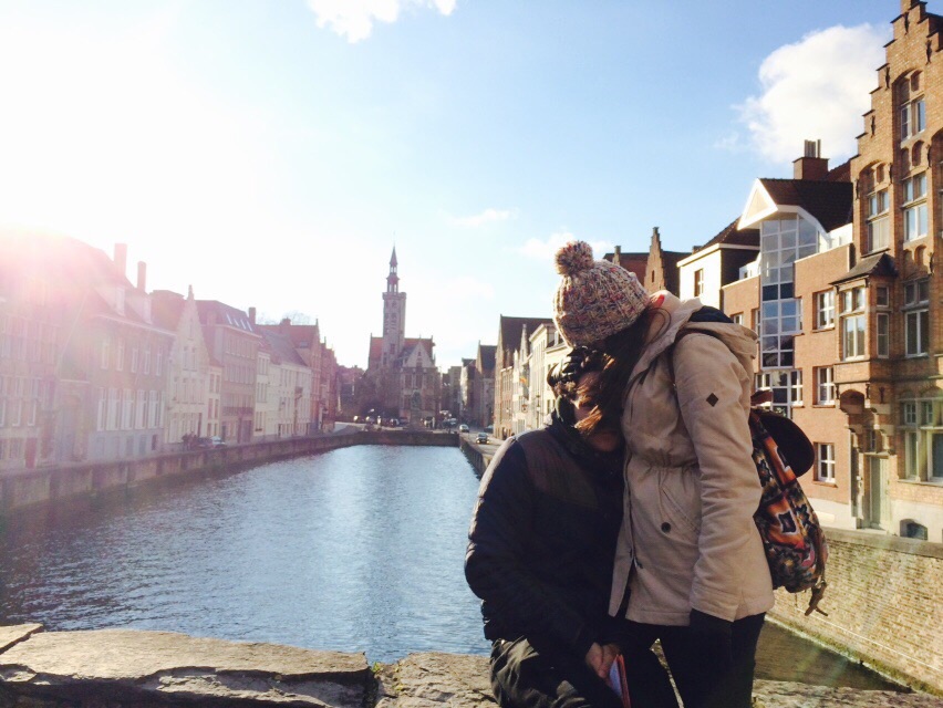 couple kissing in front of canal