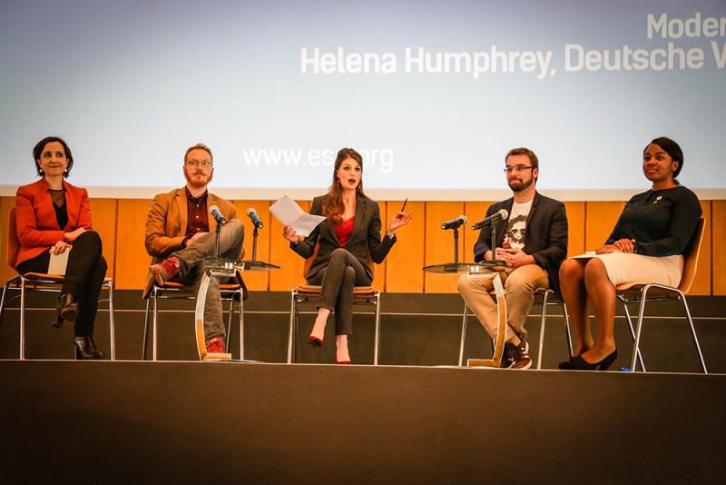 people on stage for a panel discussion