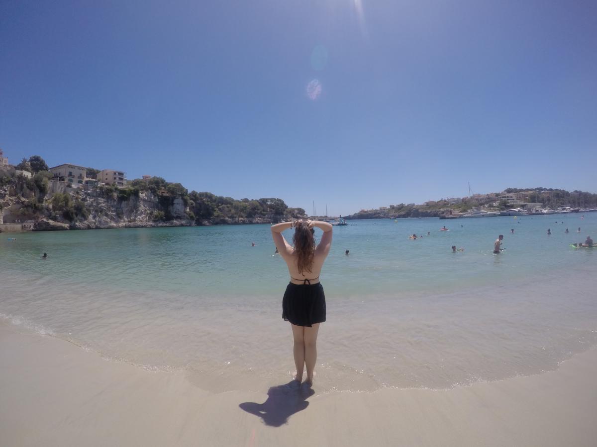 someone in front of the sea at the beach, from back