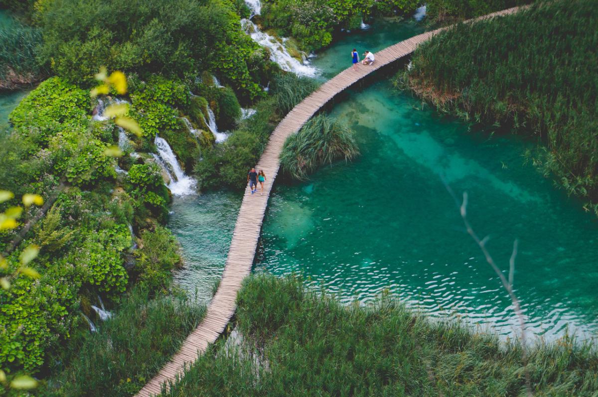 cascades, lake and people walking