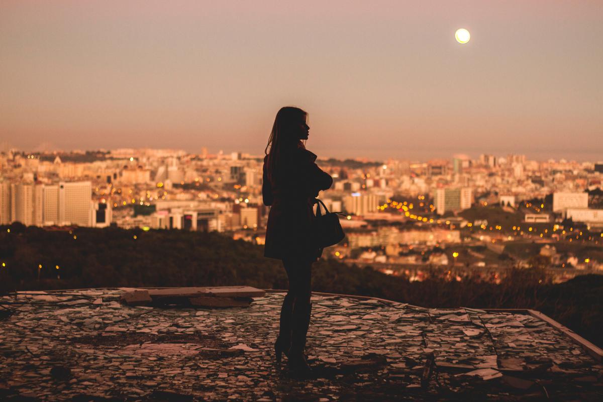 someone on a roof at sunset