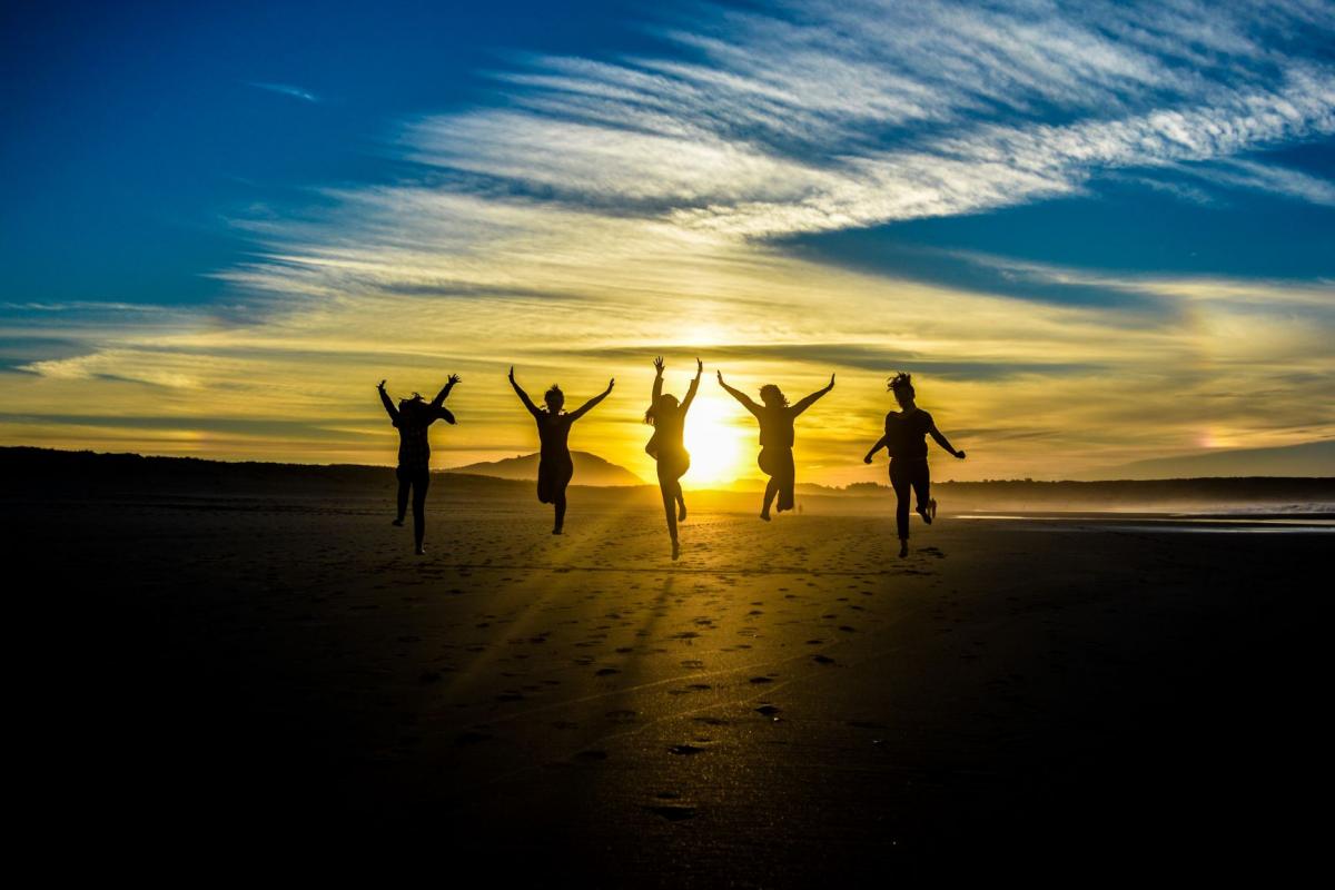 friends jumping at the beach