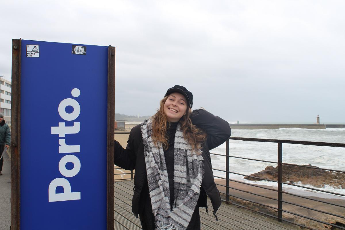 woman next to Porto sign