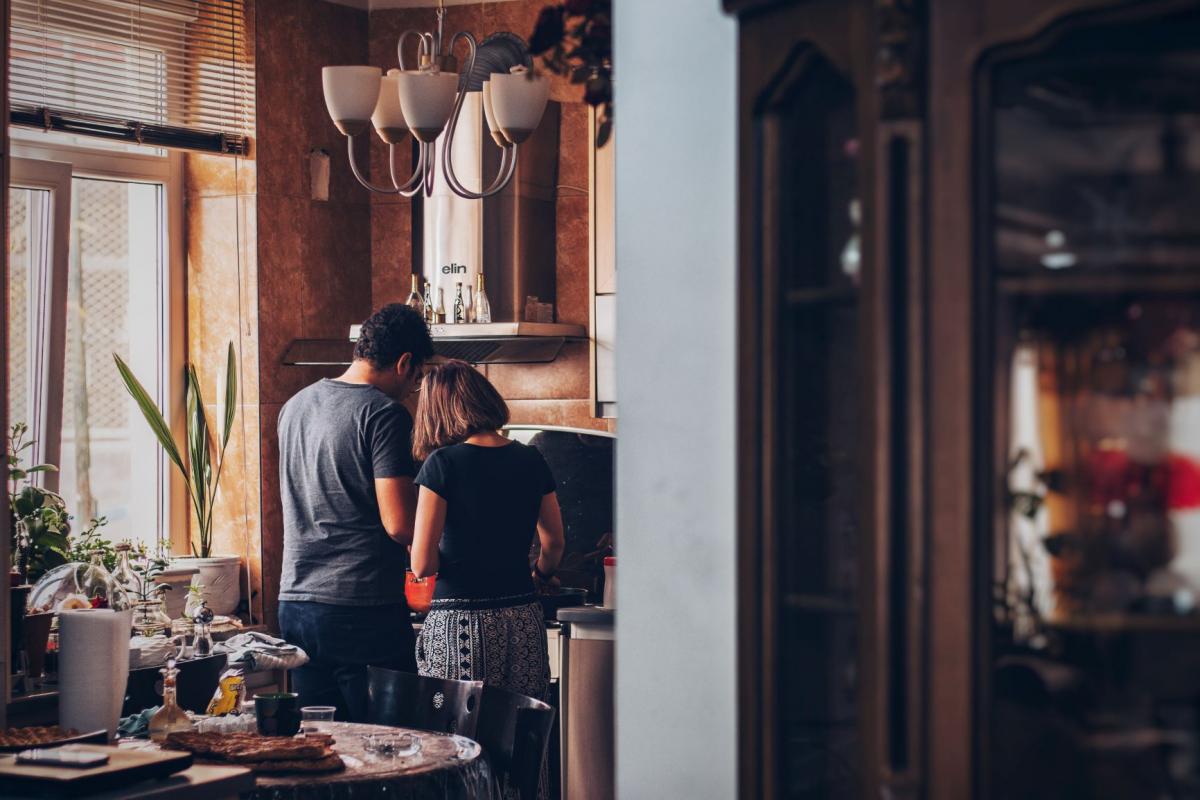 two persons cooking together