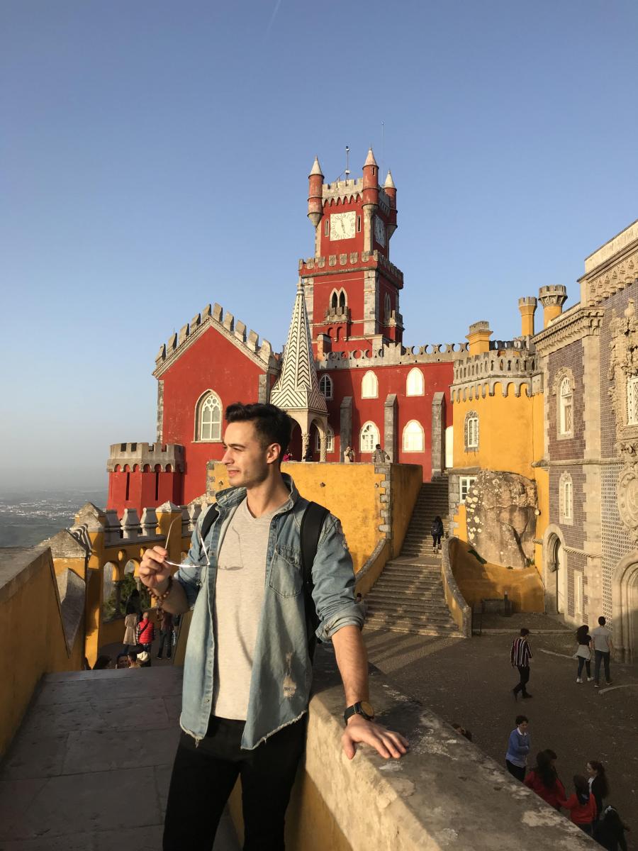 man with colourful old buildings in the back