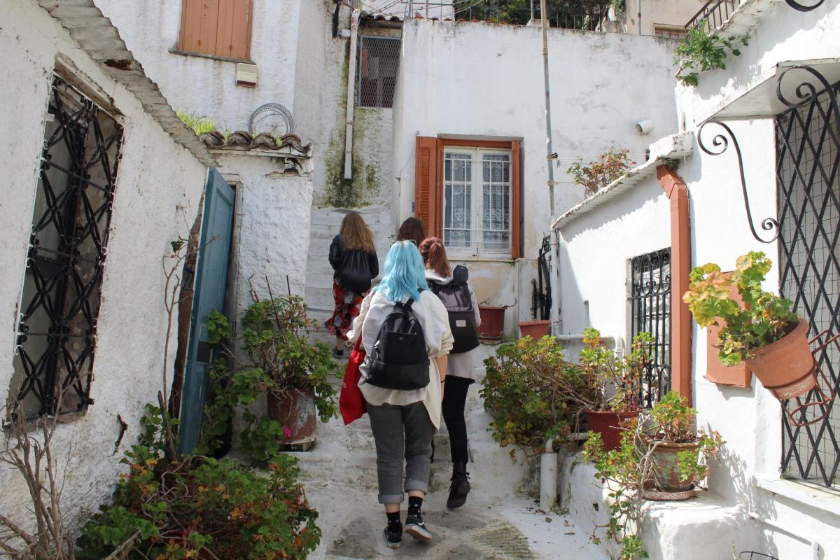 women walking between houses