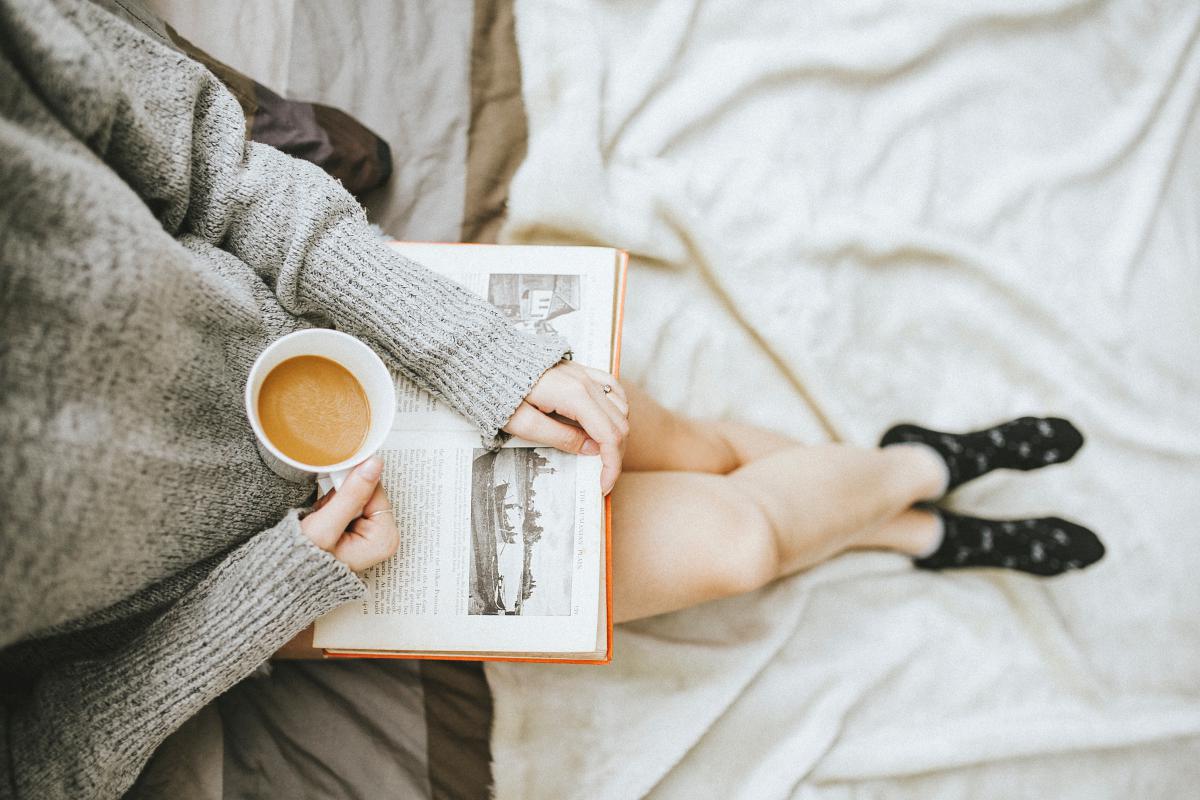 woman reading with cup