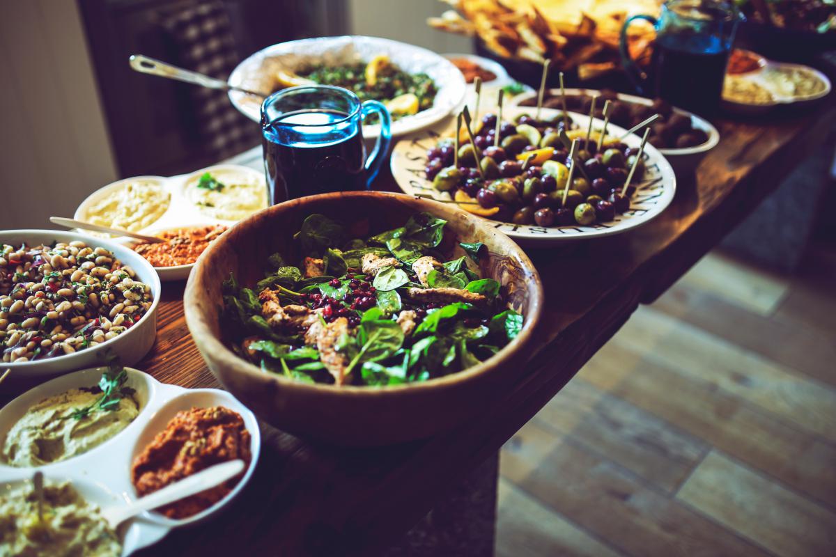 salads and hummus on table