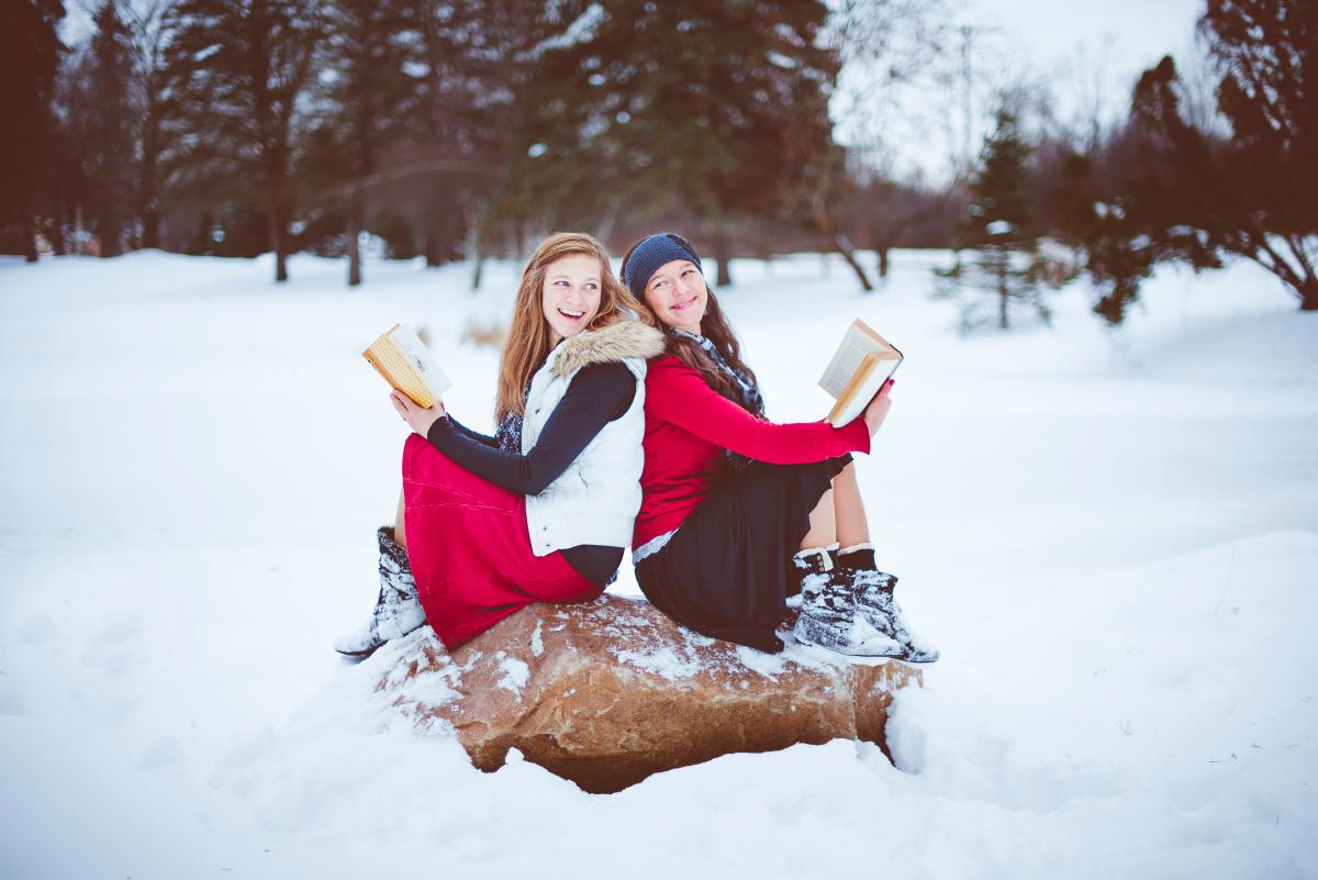 two women reading in snow