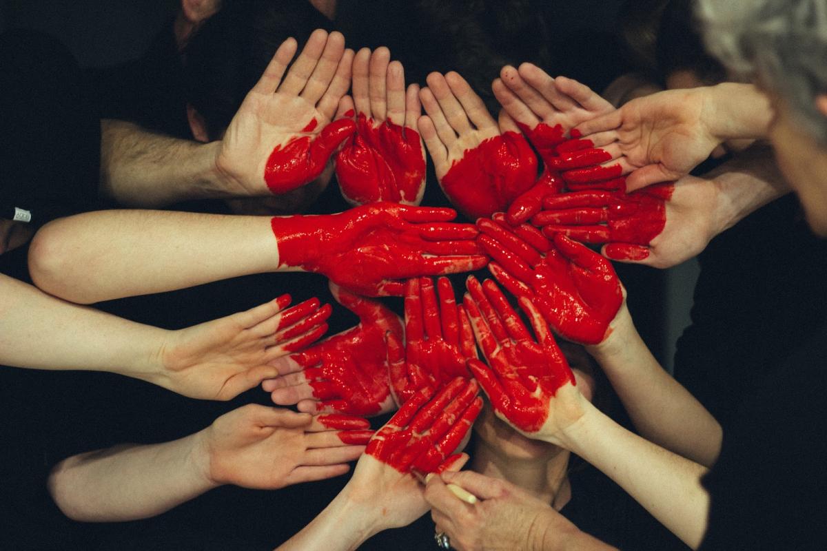 hands together and heart painted on top