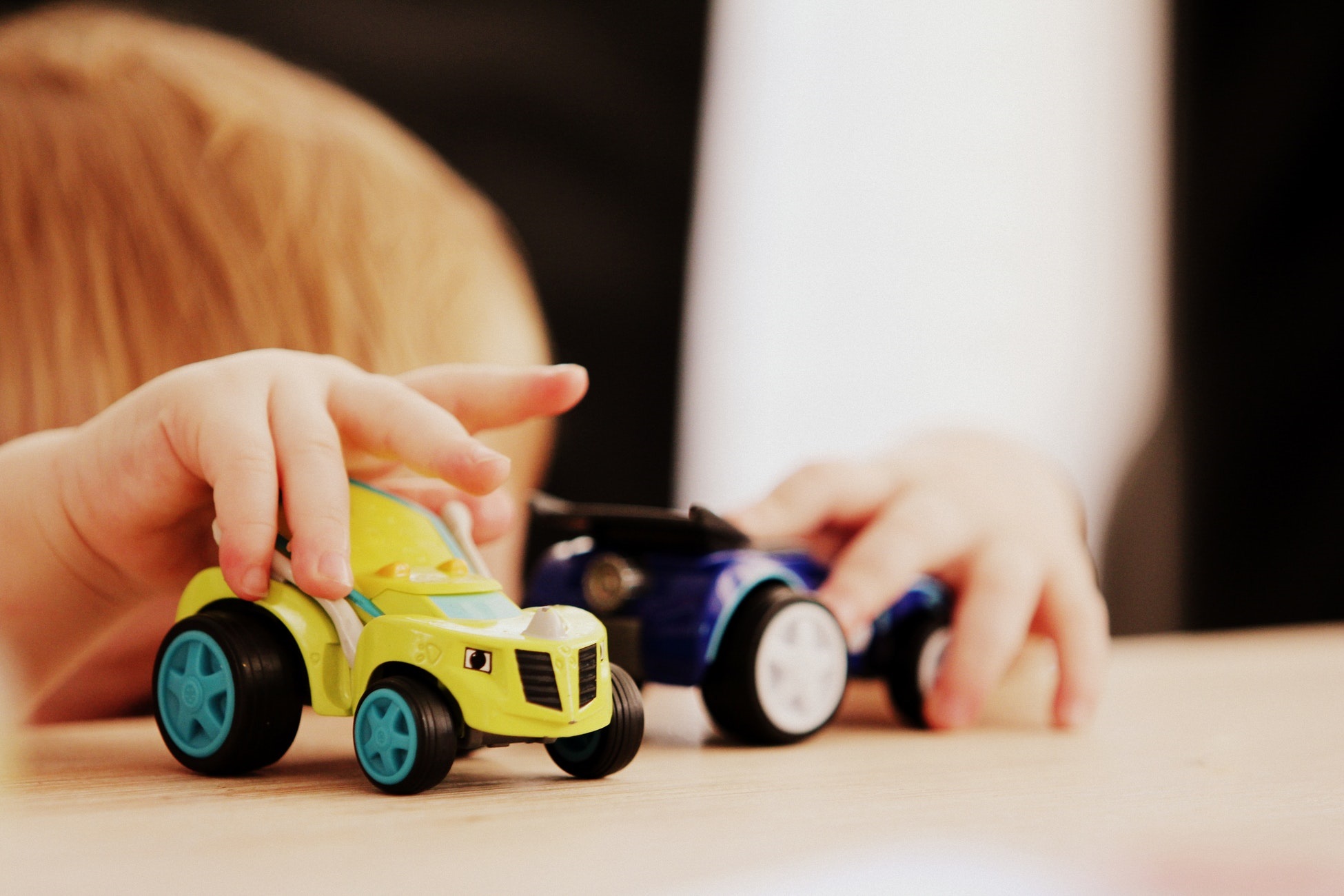 child playing with cars toys