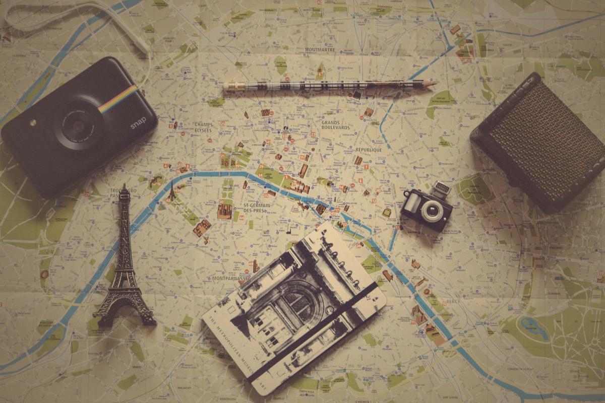 map with eiffer tower accessory, camera, notebook