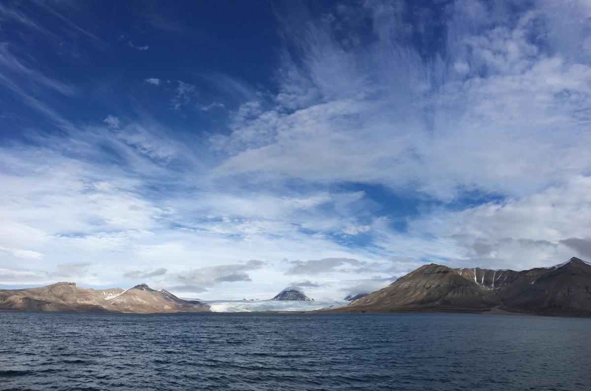 landscape with water in front, mountains at the back