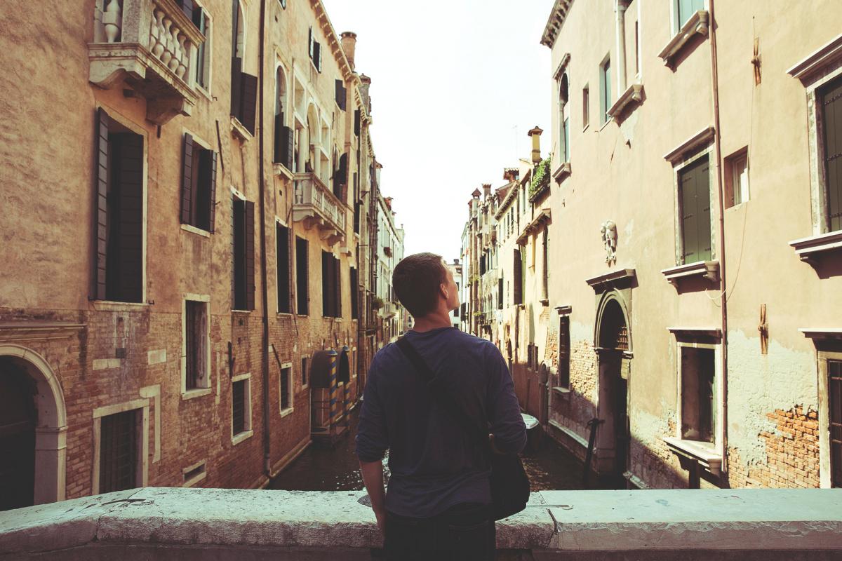 man lookin at old buildings