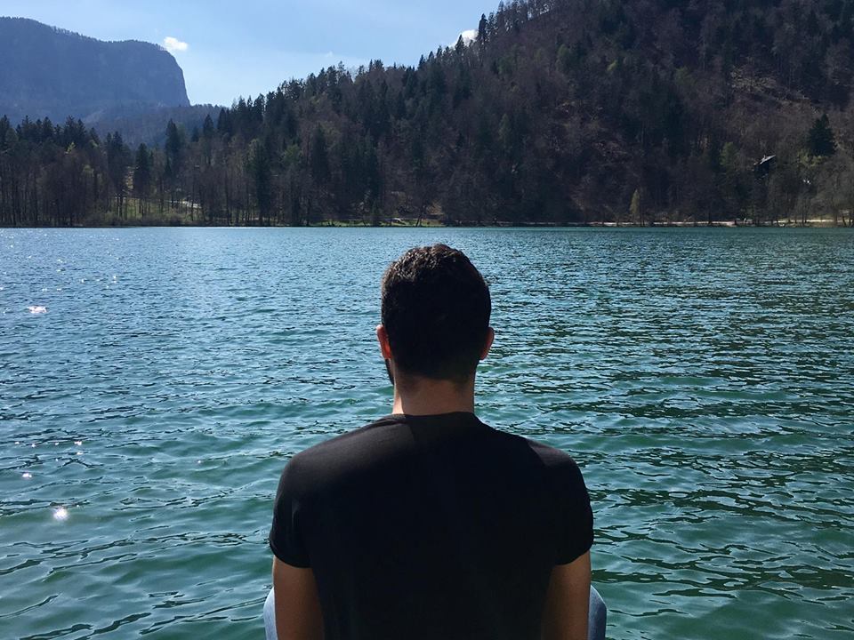 boy from back looking at lake