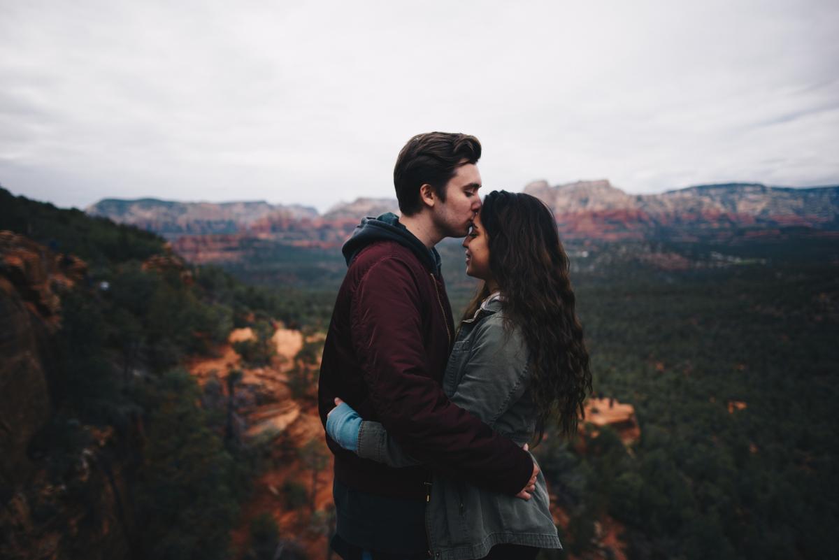 couple hugging surrounded by nature