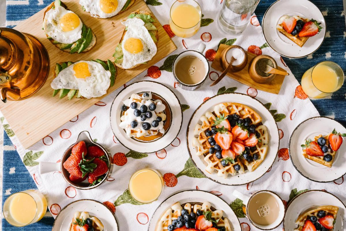 waffels, fruits, eggs, mugs