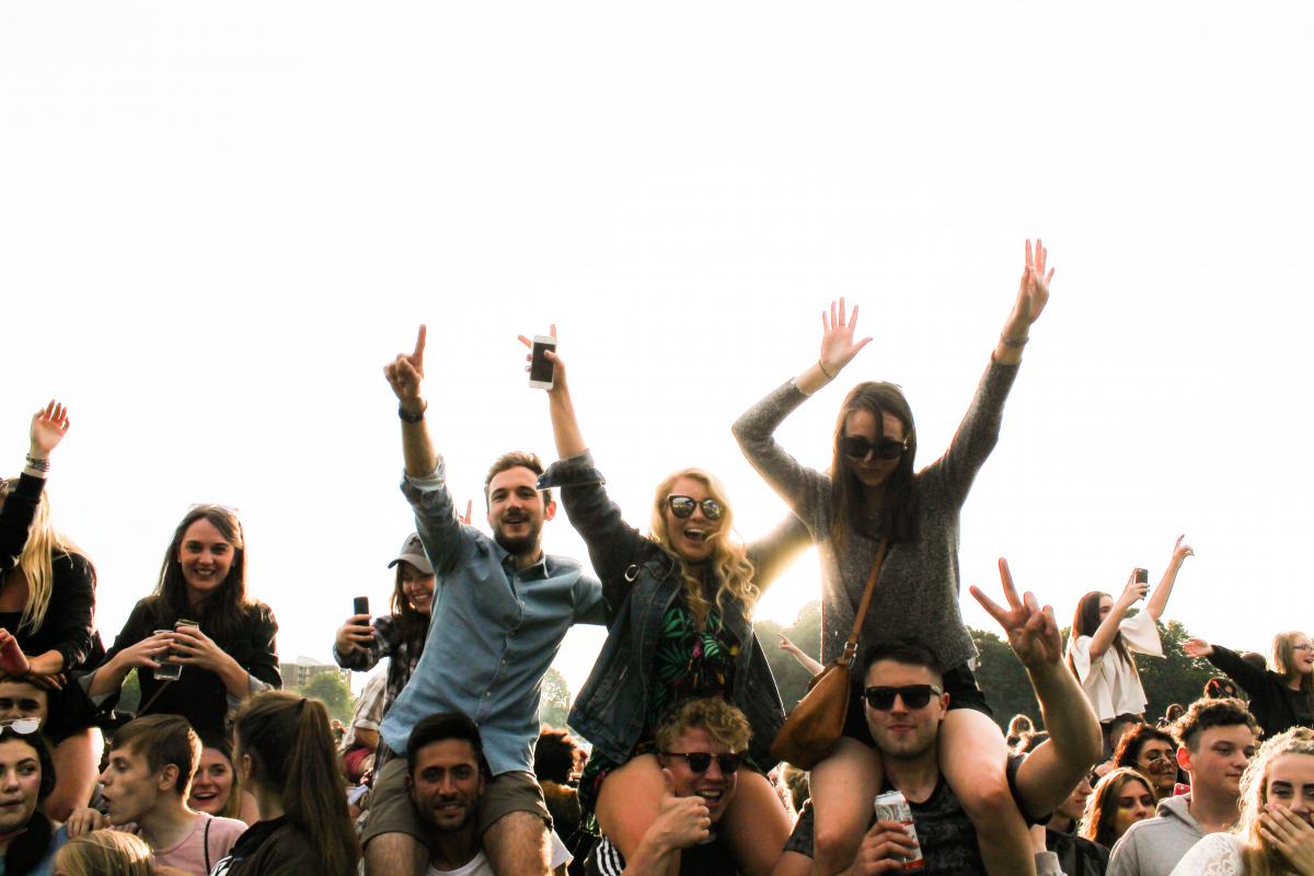 crowd of people with hands up