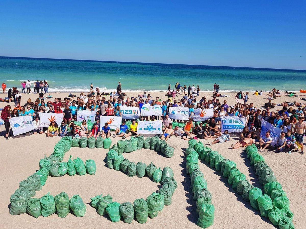 ESN written with bags of garbage on the beach