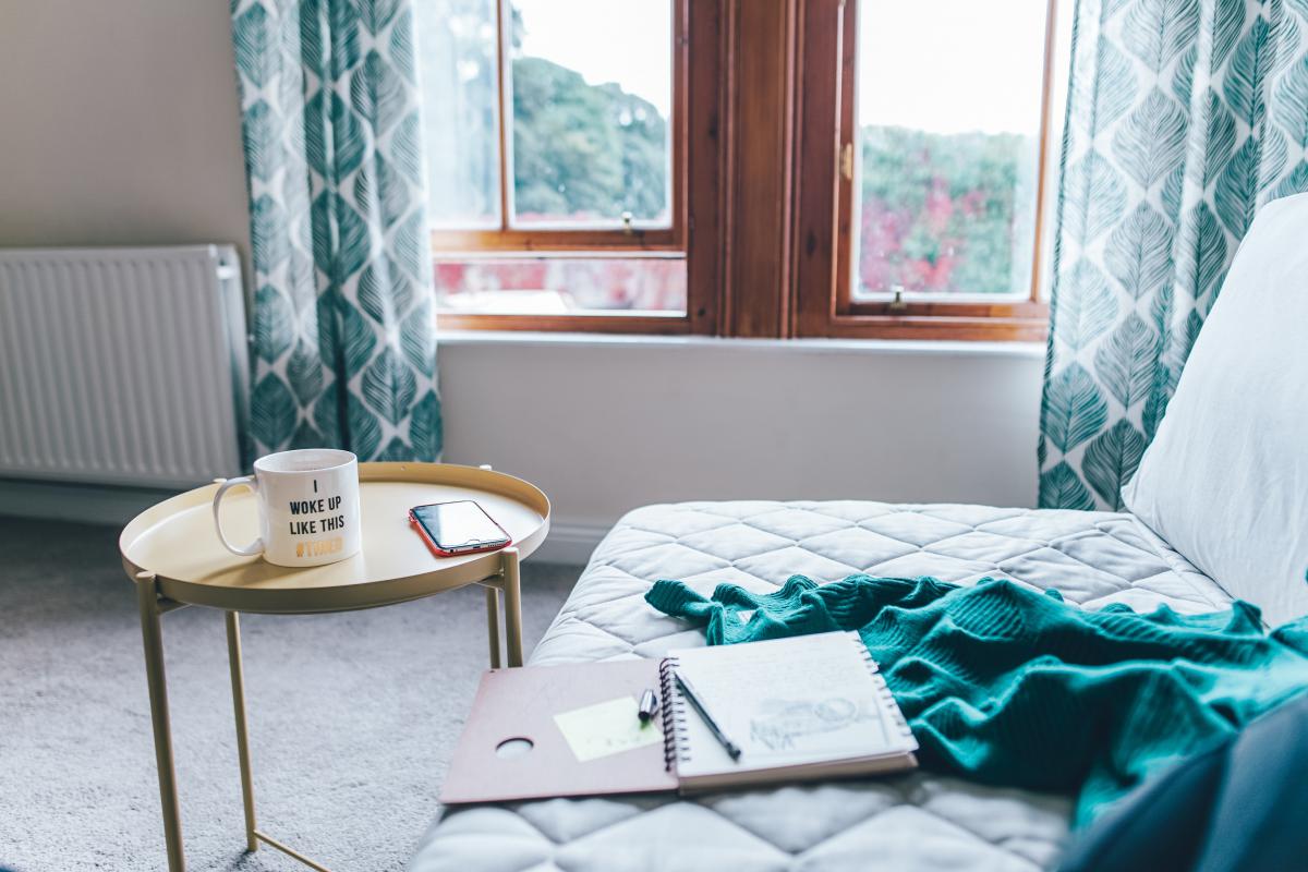 couch, tale with mug and window in the back