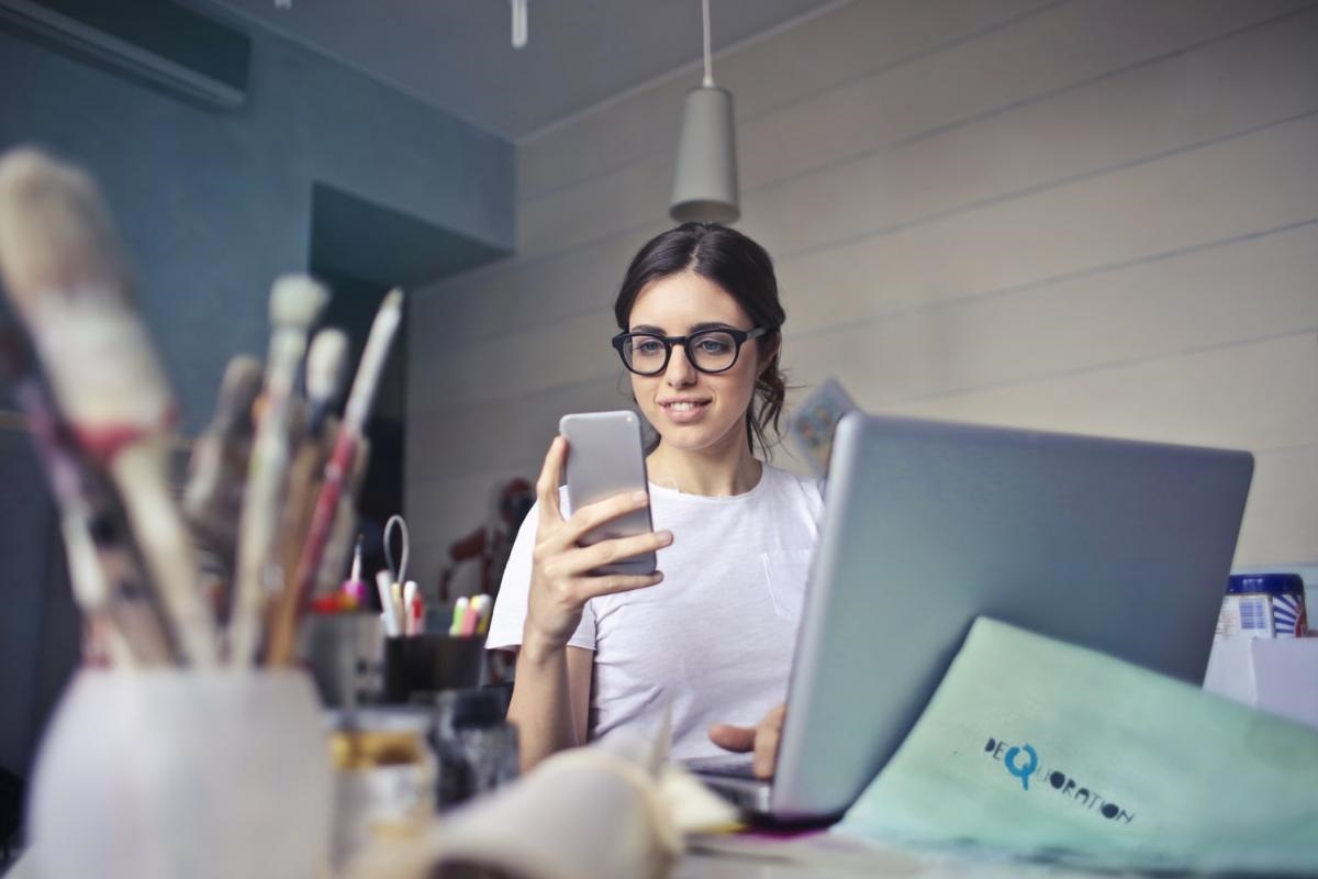 looking at smartphone, at desk