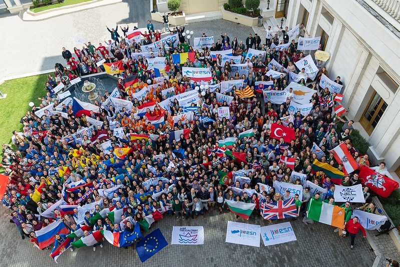 massive crowd with flags, view from above