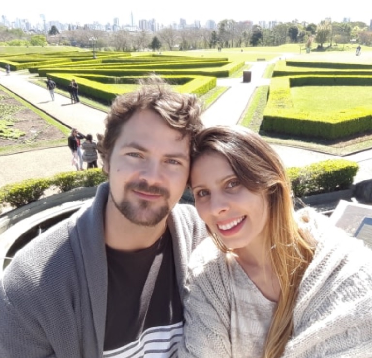 couple with garden behind