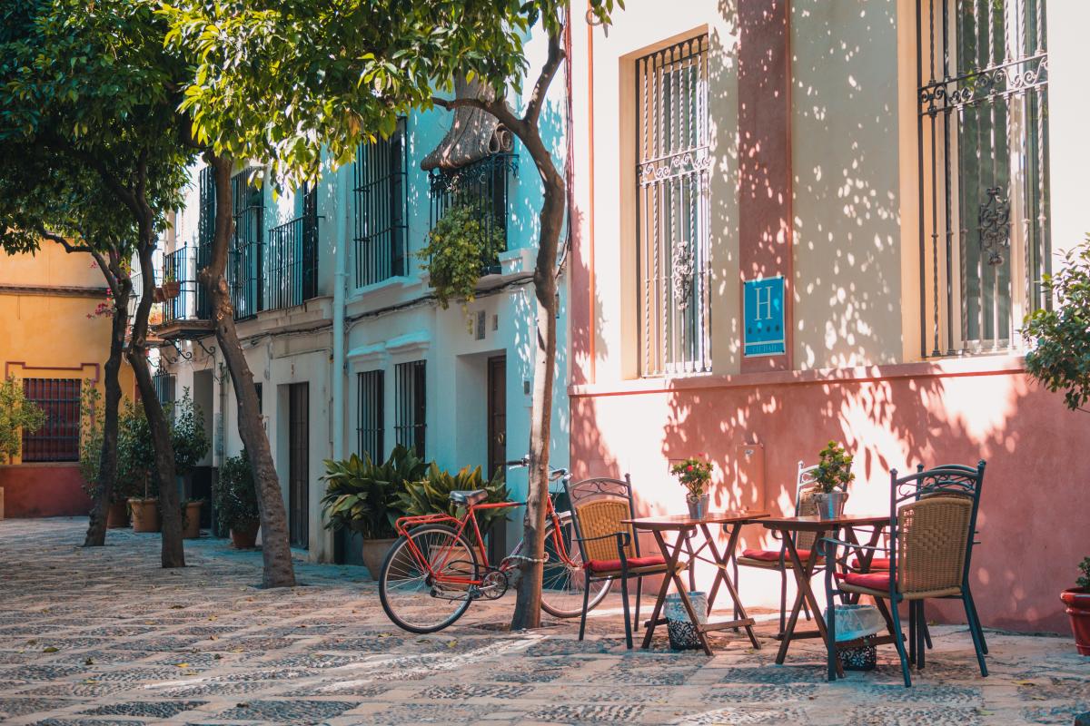 bike, table, chairs next to houses