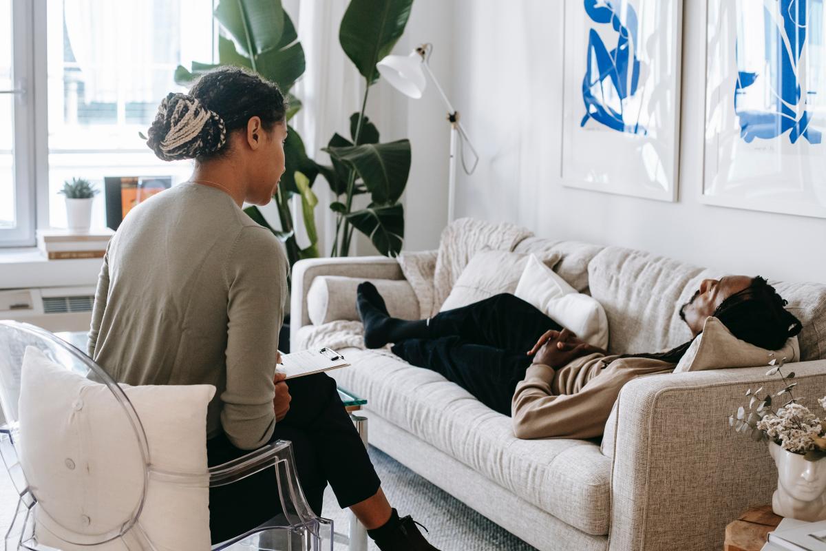 therapist listening to someone on couch