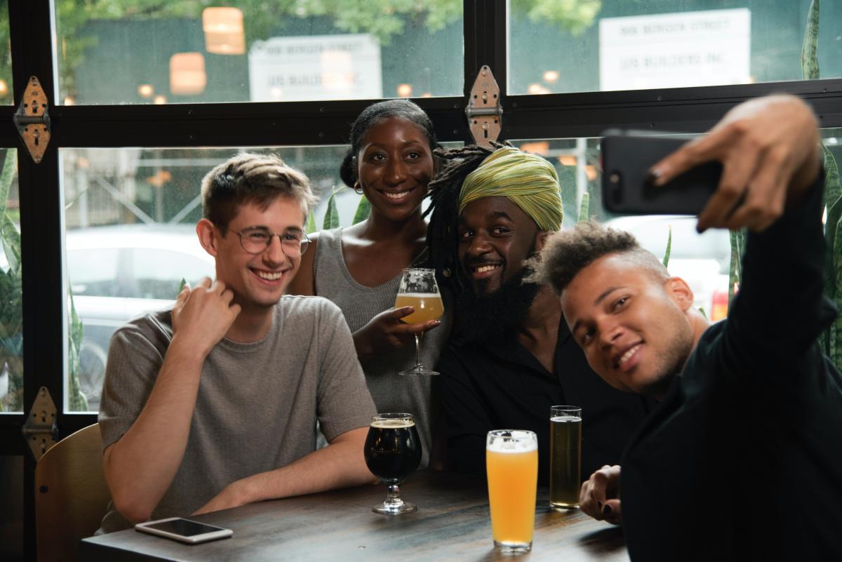 group taking selfie at cafe