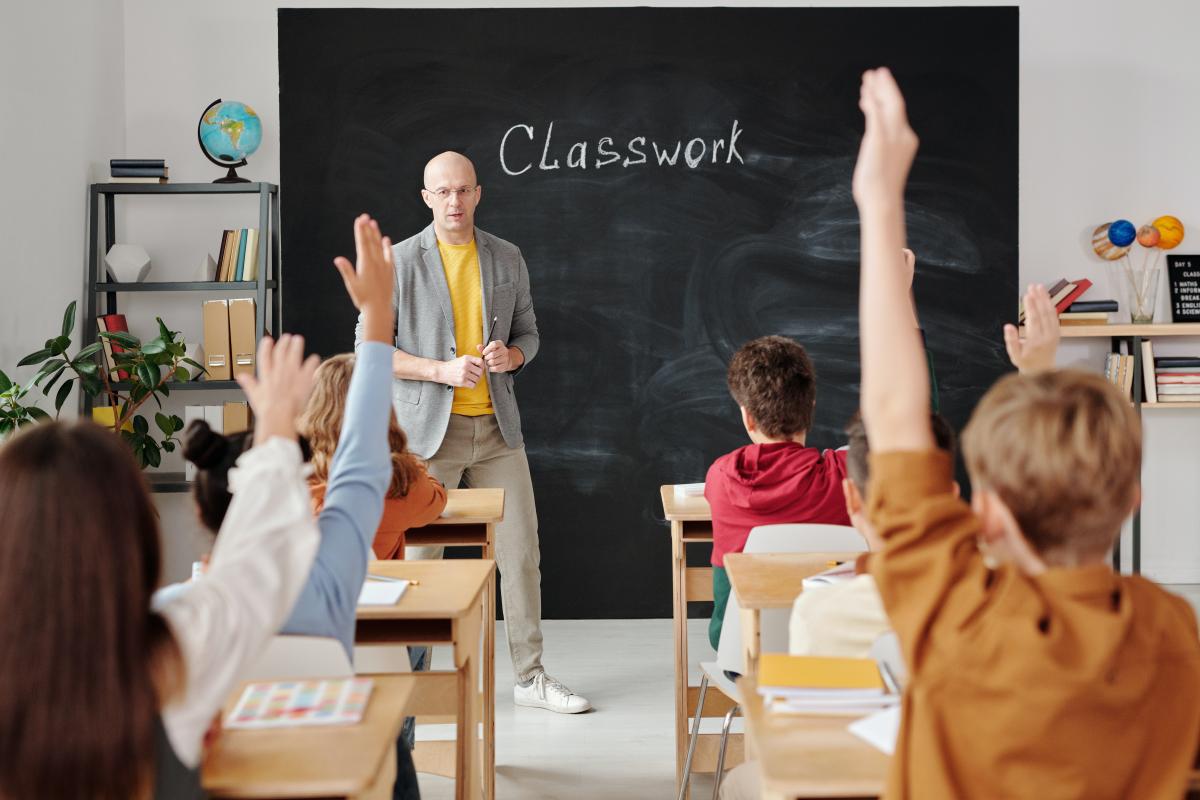 classroom with students holding hands