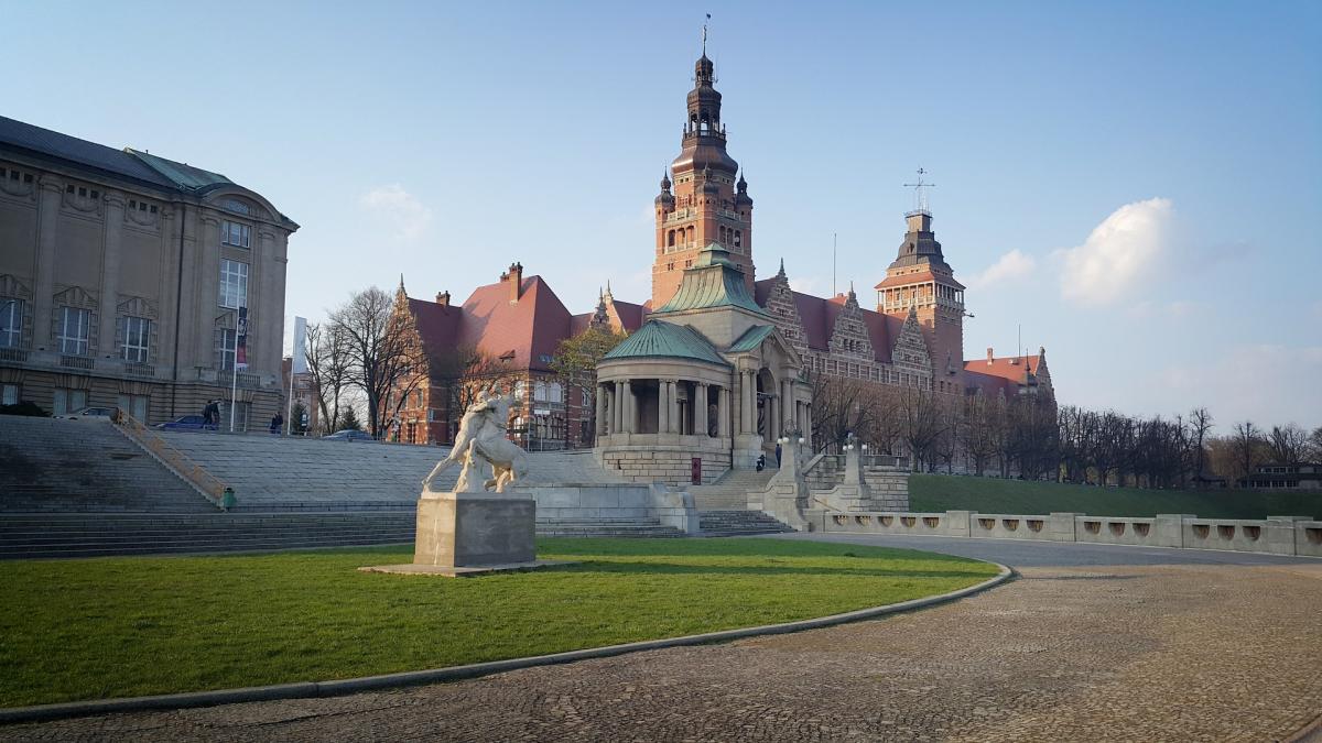 status with building behind