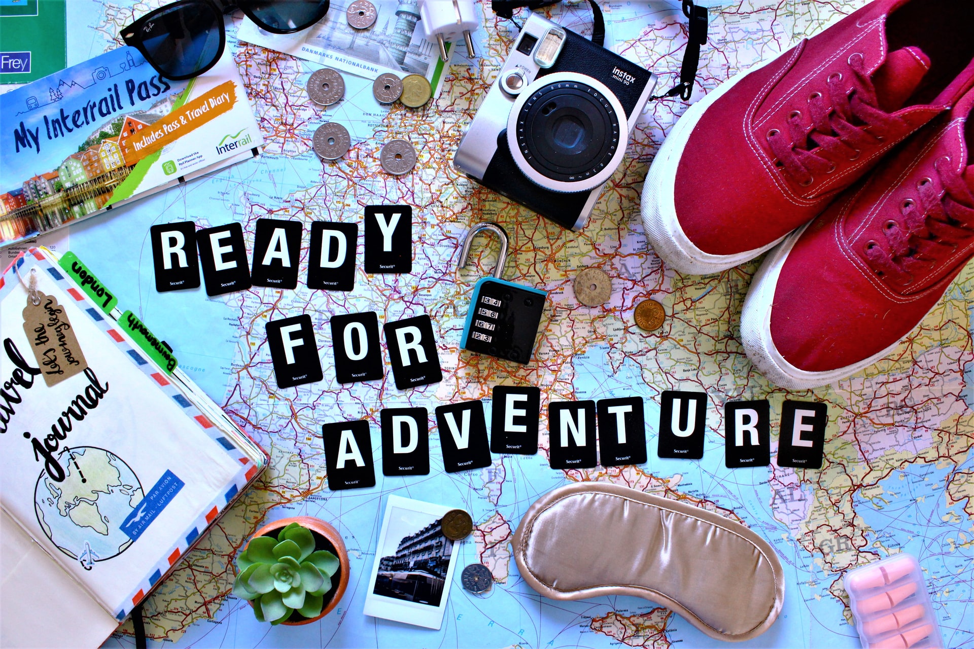 Cut letters put in a phrase "Ready for Adventure" on a map