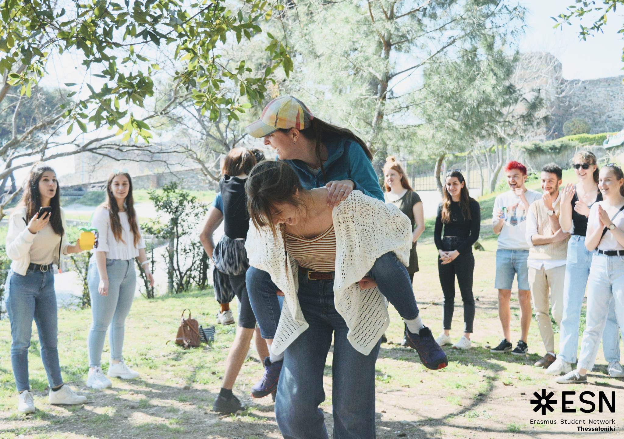 Two girls taking part in an outdoor activity, standing around the circle.