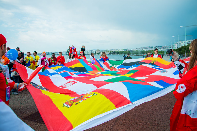 People holding a flag of different countries