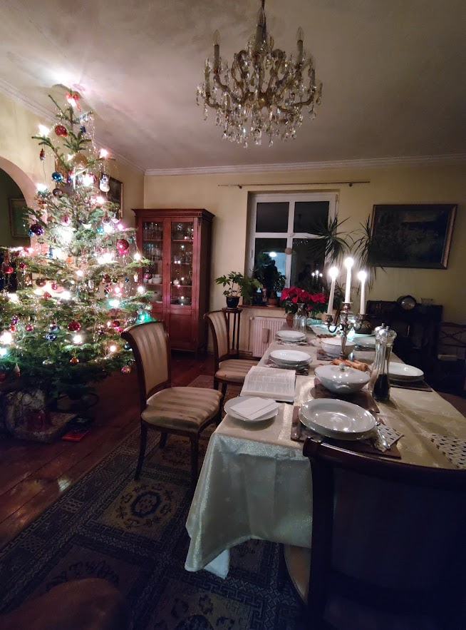 A living room decorated for Christmas, with a Christmas Tree in the corner